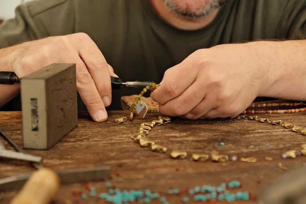 Constantinos Diamandis making a necklace in aerides jewellery Pylos