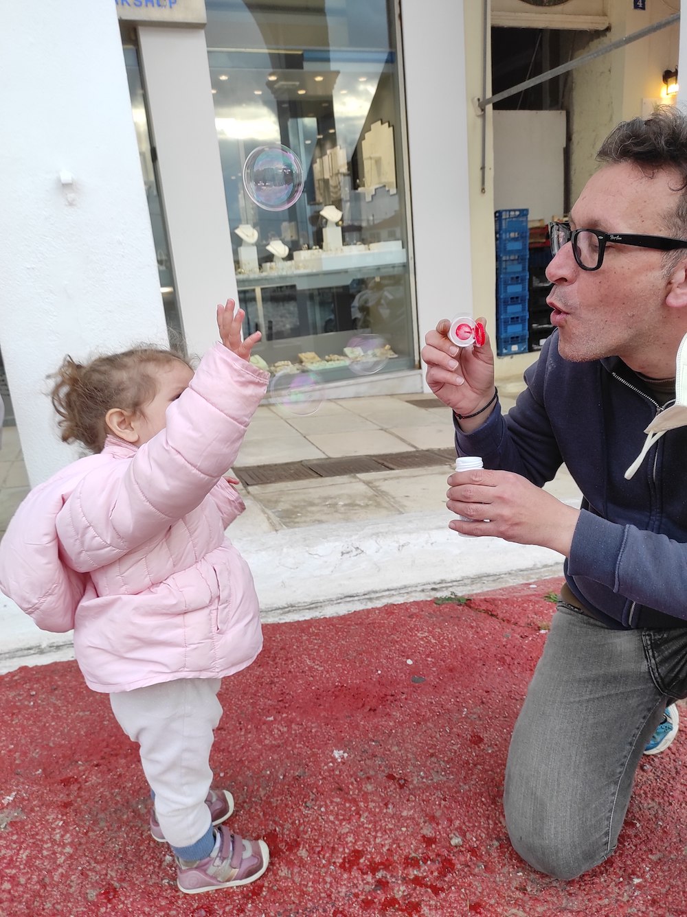 playing with my daughter in the storefront of aerides jewellery shop in Pylos